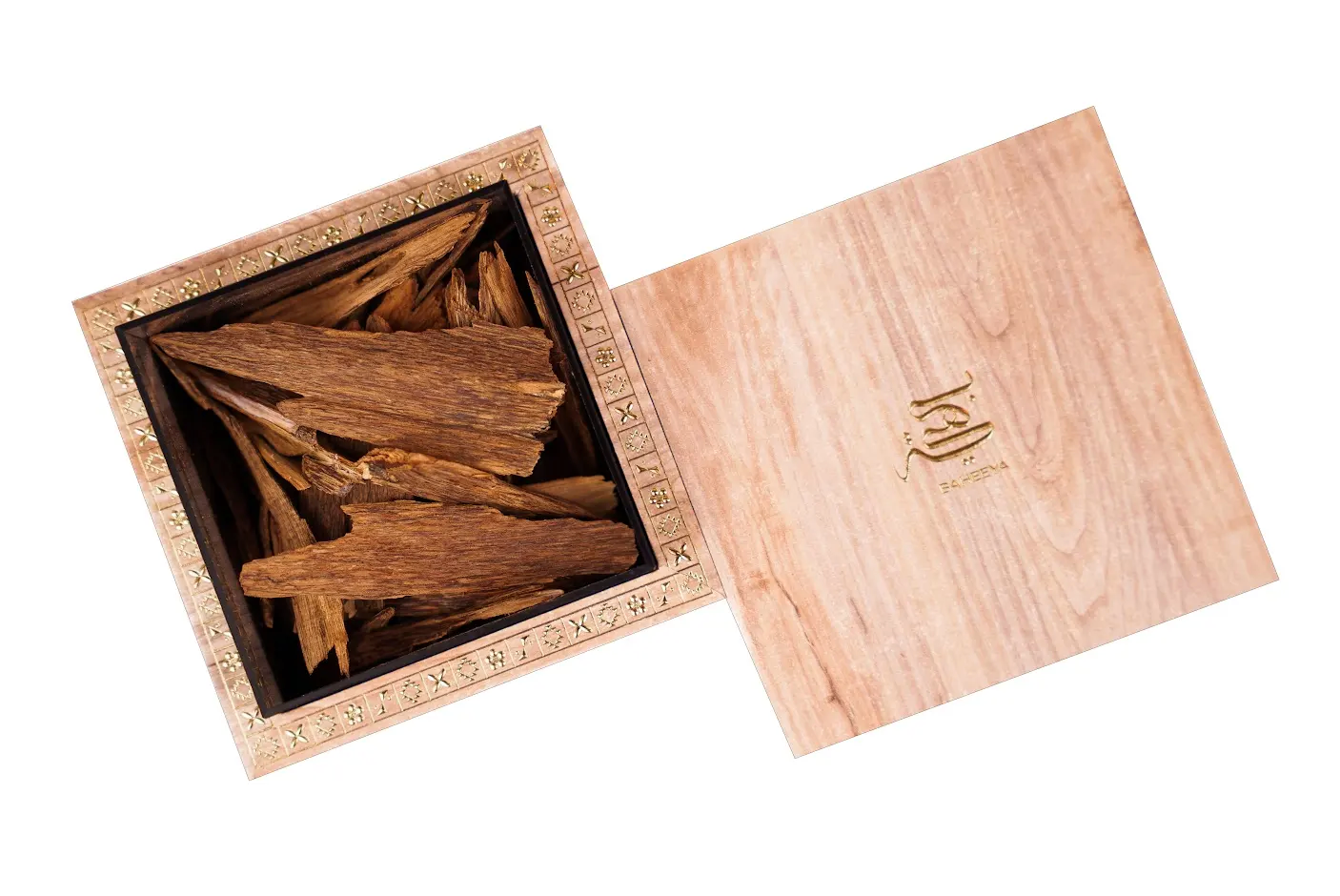 Wooden box with incense sticks inside on a white background
