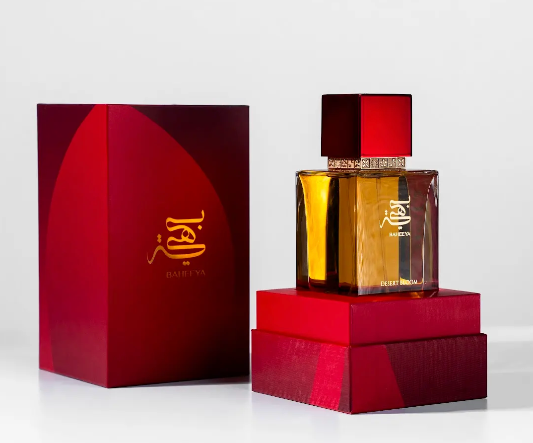 Perfume bottle and packaging with a red box on a white background